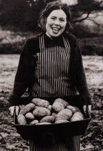 Lucy carrying a large basket of potatoes